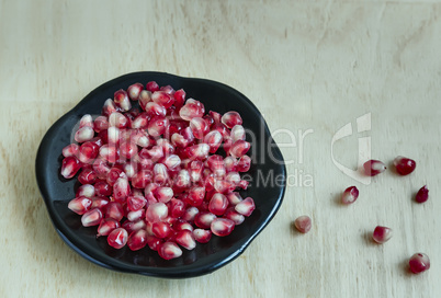 Grains of pomegranate fruit on the plate.