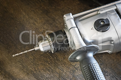 Small electric drill with a drill bit