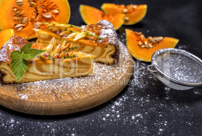 pumpkin pie on a round wooden board