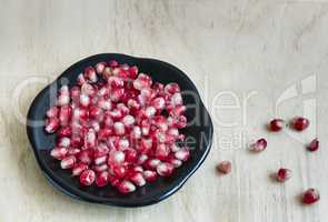 Grains of pomegranate fruit on the plate.