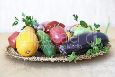 Various vegetables on a wicker dish on the table.