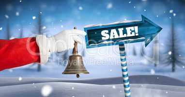 Sale text and Santa holding bell with Wooden signpost in Christmas Winter landscape