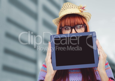 Woman holding tablet with building background