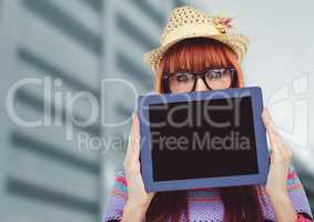 Woman holding tablet with building background