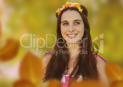 Beautiful smiling woman in forest with leaves