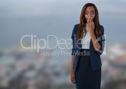 Businesswoman with hand over mouth in city