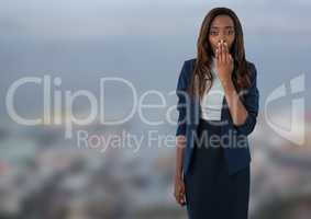 Businesswoman with hand over mouth in city