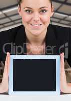 Woman holding tablet with warehousse background