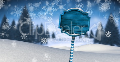 Wooden signpost in Christmas Winter landscape