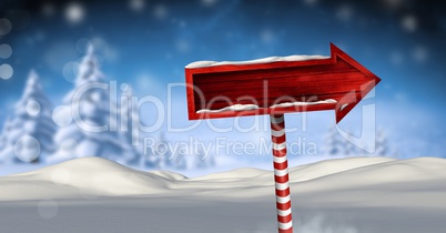 Wooden signpost in Christmas Winter landscape