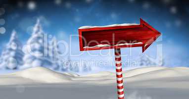 Wooden signpost in Christmas Winter landscape