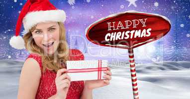 Happy Christmas text and female Santa holding gift with Wooden signpost in Christmas Winter landscap