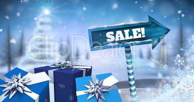 Sale text and gifts with Wooden signpost in Christmas Winter landscape