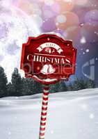 Merry Christmas text on Wooden signpost in Christmas Winter landscape