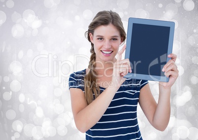 Woman holding tablet with sparkling lights background