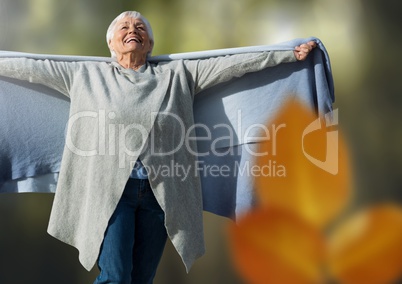 Old woman free in forest with leaves