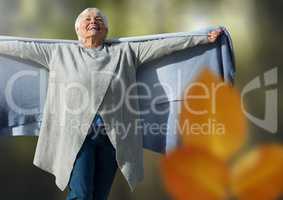Old woman free in forest with leaves