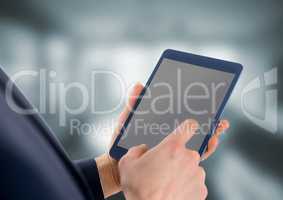 Person holding tablet with office background