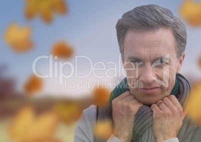 Man's face in landscape with leaves
