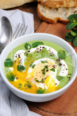 Pea puree soup with poached egg  and peppermint