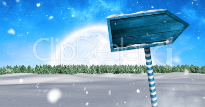 Wooden signpost in Christmas Winter landscape