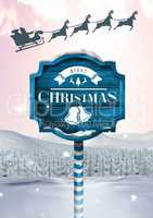 Merry Christmas text on Wooden signpost in Christmas Winter landscape and Santa's sleigh and reindee