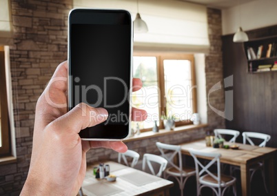Hand using phone with cafe background