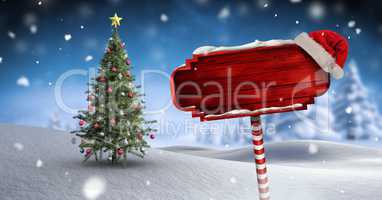 Wooden signpost in Christmas Winter landscape and Santa hat with Christmas tree