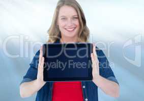 Woman holding tablet with blue light streaks background