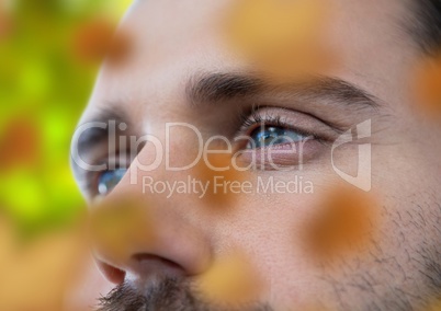 Man's face in forest with leaves
