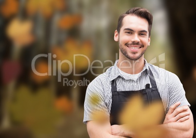 Man with apron in forest with leaves