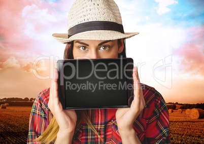 Woman holding tablet with colorful landscape background