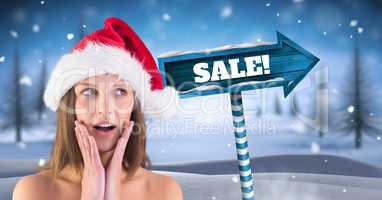 Sale text and female Santa with Wooden signpost in Christmas Winter landscape