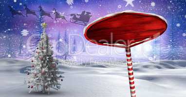 Wooden signpost in Christmas Winter landscape and Santa's sleigh and reindeer's and Christmas tree