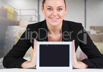 Woman holding tablet with stock storage room background