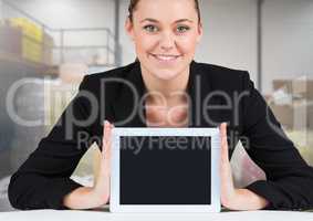 Woman holding tablet with stock storage room background