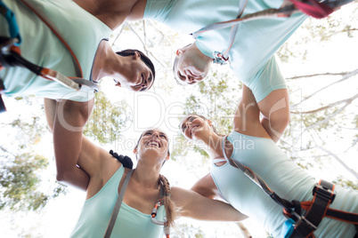 Happy friends forming huddle Happy friends forming huddle