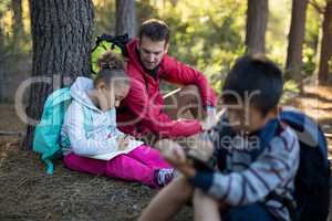 Teacher assisting girl in study