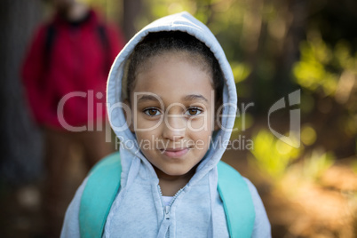 Close-up of cute girl standing with school bag