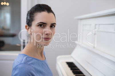 Portrait beautiful woman playing piano