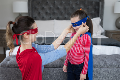 Mother and daughter pretending to be superhero