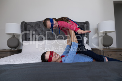 Mother and daughter having fun in bedroom