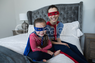 Mother and daughter pretending to be superhero