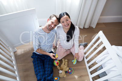 Overhead of happy couple playing with toys