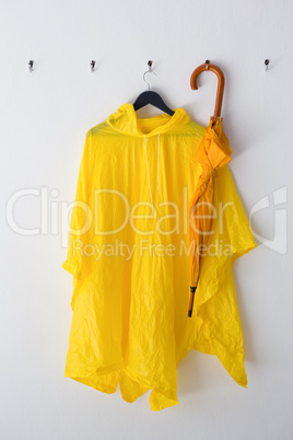 Raincoat and umbrella hanging on hook