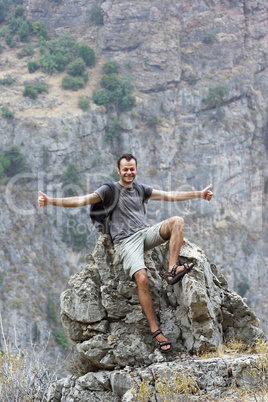 male backpacker showing thumbs up