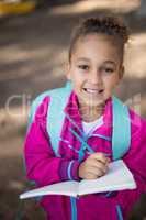 Portrait of girl writing in book