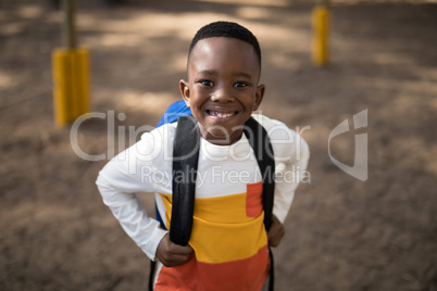 Close-up of cute boy standing with school bag