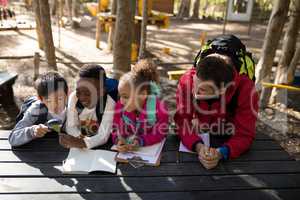 Teacher assisting kids in studying