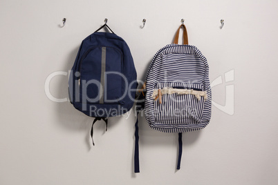 Schoolbags hanging on hook